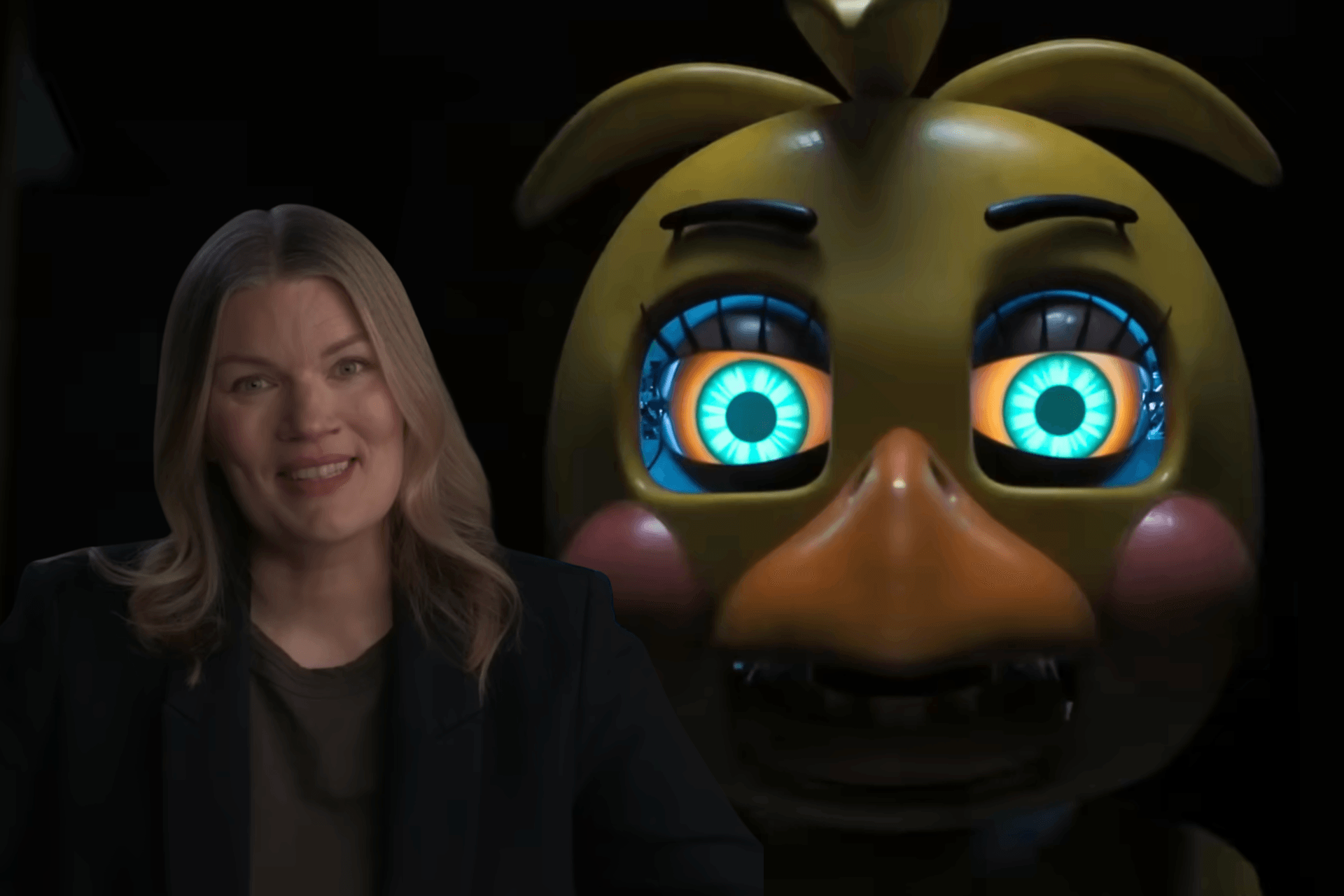 'Five Nights at Freddy's 2' director Emma Tammi poses next to the animatronic Toy Chica character.