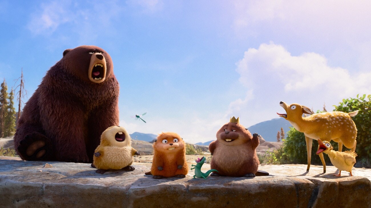 A roaring bear, a doe and a duckling, and three beaver characters gather on a stone wall in a forest in a scene from Pixar's 'Hoppers'.
