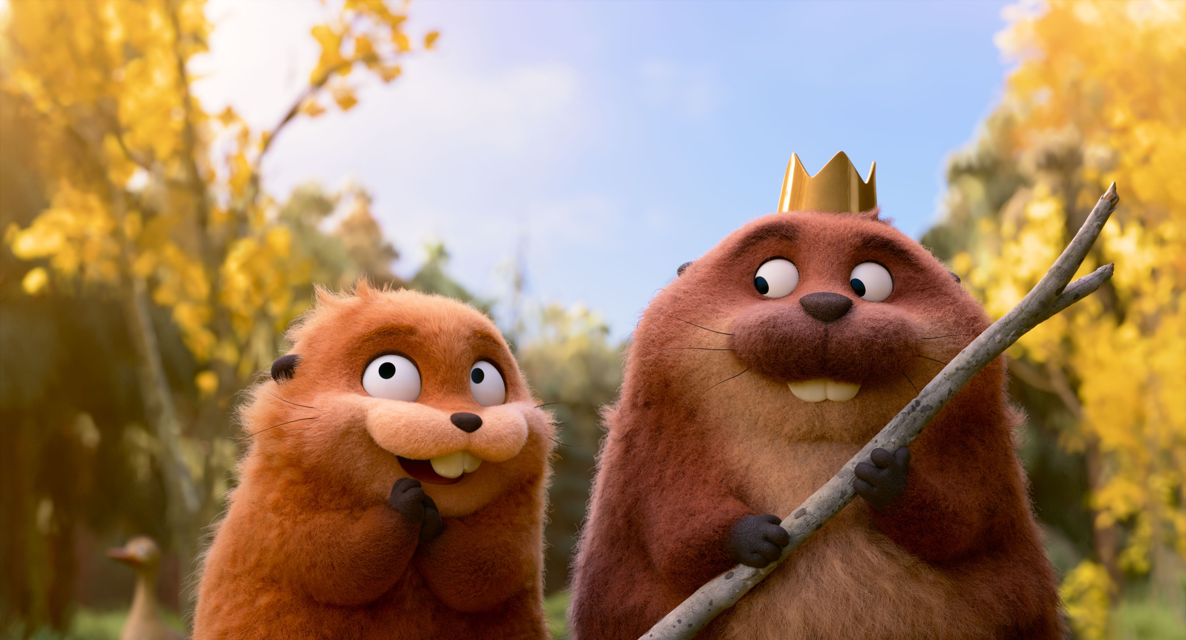 Two animated beaver characters from Pixar's 'Hoppers' stand in a sunlit forest, one wearing a small gold crown and holding a stick.